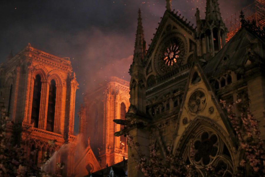 Sparks fill the air as Paris Fire brigade members spray water to extinguish flames as the Notre Dame Cathedral burns in Paris, France, April 15, 2019.   REUTERS/Philippe Wojazer